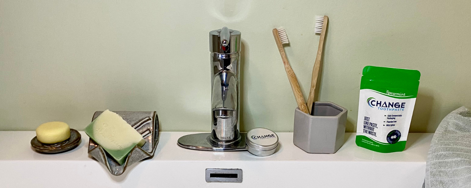 Shop Dire bathroom counter with Change Toothpaste and bamboo toothbrushes displayed.