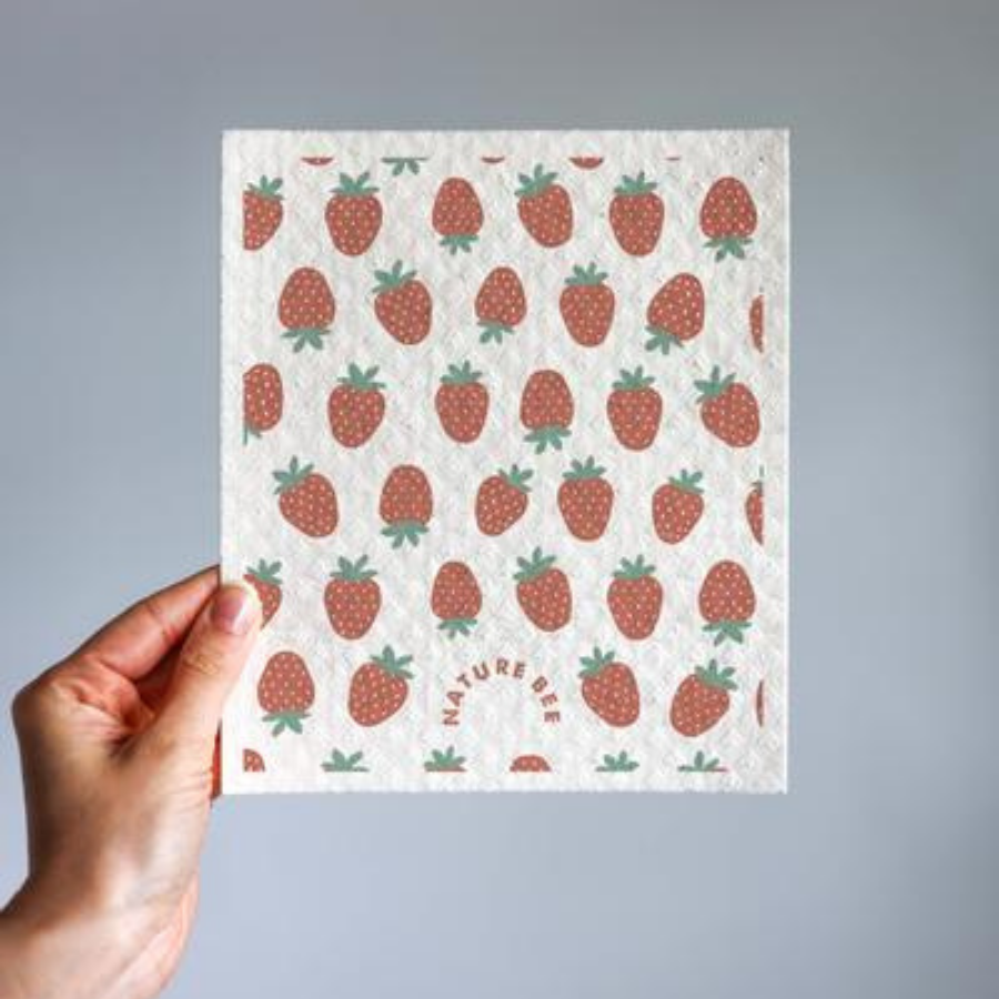 Hand holding Nature Bee strawberry patterned Swedish dishcloth.