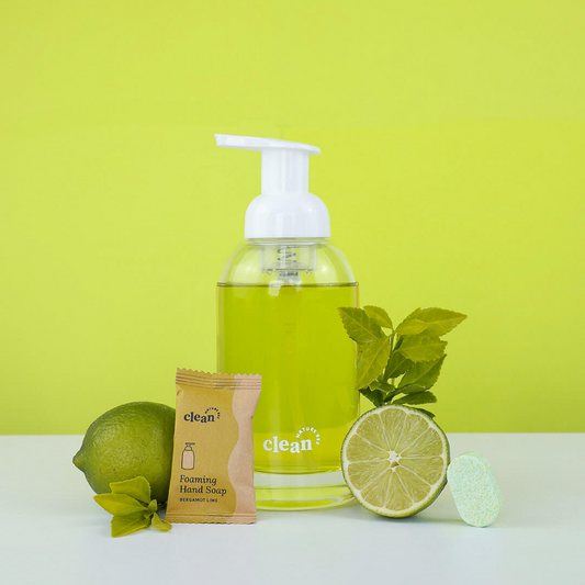 Glass, foaming hand soap dispenser containing lime green Nature Bee hand soap.
